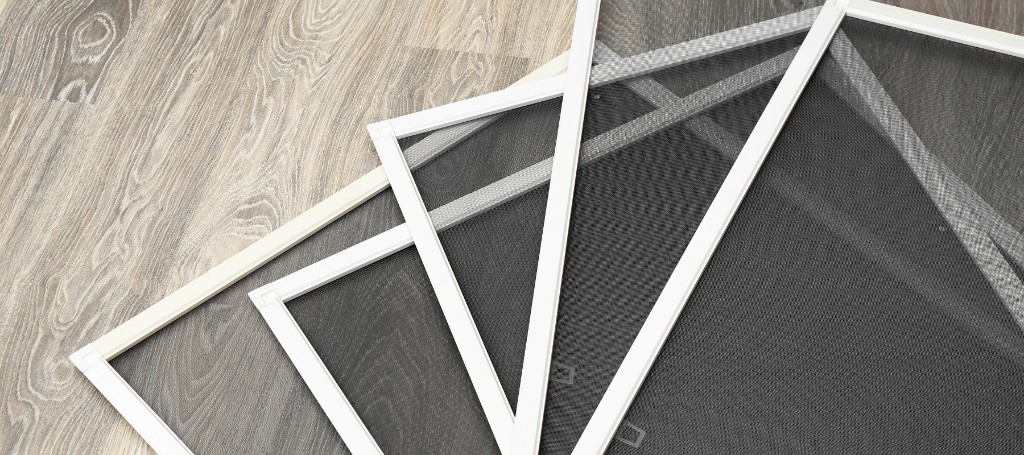 Five overlapping white-framed window screens are displayed against a wooden floor background. The arrangement suggests a focus on home improvement or energy efficiency.